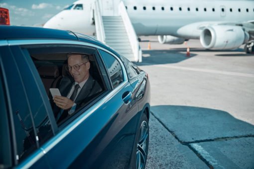 London Airport Transfer - Cheap Heathrow Minicabman in chauffeur car next to private plane